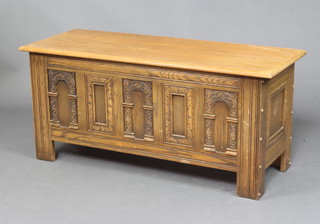A 17th Century style carved oak coffer of panelled construction and with hinged lid 51cm h x 114cm w x 45cm d 