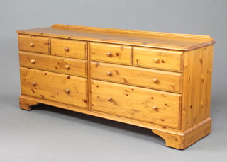 A Ducal style pine chest of 4 long and 4 short drawers with raised back on bracket feet 74cm h x 169cm w x 45cm d 