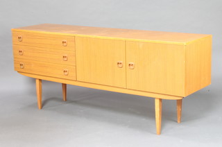 A mid Century wooden laminate sideboard fitted 3 drawers flanked by a pair of cupboards, on square tapered supports 72cm h x 176cm w x 45cm d (some scratches to the top) 