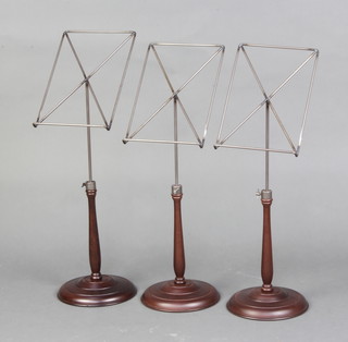 Three steel and turned wooden adjustable music stands on turned bases 64cm h x 19cm 