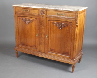 A French carved oak Art Nouveau sideboard with pink veined marble top fitted 2 drawers above a double cupboard enclosed by panelled doors, raised on turned and reeded supports 104cm h x 123cm w x 46cm d  (small section of marble missing to the top) 