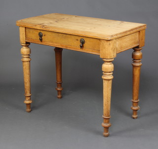A Victorian pine and oak side table fitted a frieze drawer, raised on turned supports 76cm x 88cm x 49cm 