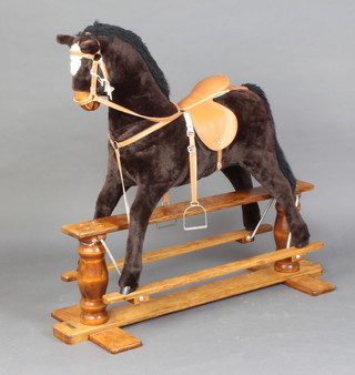 A Mamas & Papas fabric covered rocking horse on a wooden base 110cm h x 45cm w   