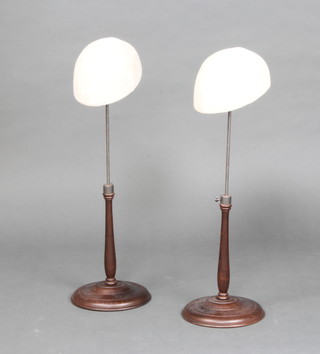 A pair of wooden and metal milliners adjustable display hat stands 67cm h x 19cm w x 14cm d 