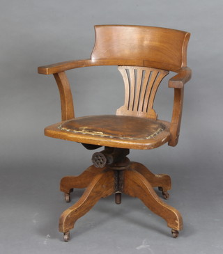 A 1920's oak tub back revolving office chair 