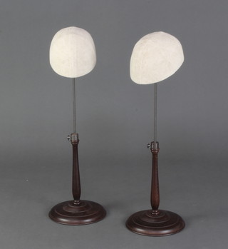 Two milliner's metal and turned mahogany adjustable hat display stands 65cm h  