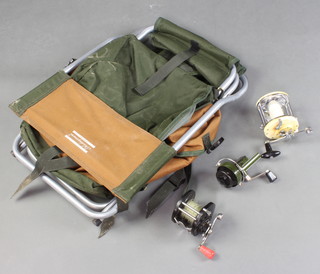 A Mitchell 604 fishing reel, a Fisherman 50100 reel and 1 other fishing reel together with a Shakespeare tubular metal folding seat 