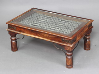 A rectangular Eastern hardwood coffee table with pierced grilled iron and plate glass top, raised on turned supports 40cm h x 90cm w x 60cm d 