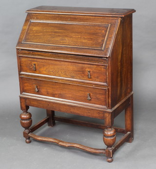 An oak Jacobean style bureau with two long drawers, 102cm h x 79cm w x 38cm d 