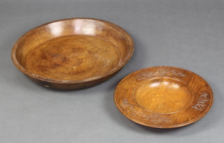 A turned wooden dish 8cm x 54cm and a turned carved oak bowl 5cm x 41cm 