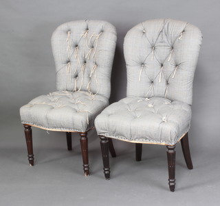 A pair of Victorian style dining chairs upholstered in Prince of Wales check material raised on turned and fluted supports