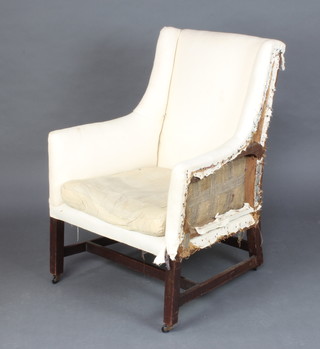 A Georgian mahogany armchair upholstered in white material, raised on square tapered supports (requires upholstery) 