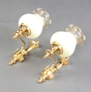 A pair of gilt metal wall light brackets with opaque glass shades 