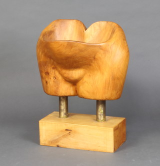 Mid Century, a carved elm sculpture in the form of a female pelvis, raised on a beech base 55cm h x 46cm w x 32cm d 