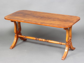 A Georgian style yew and crossbanded rectangular coffee table raised on standard end supports with turned stretcher 42cm h x 91cm w x 46cm d 