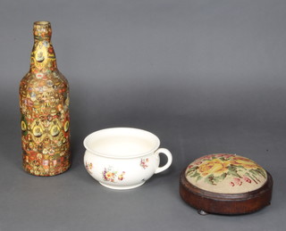 A large bottle decorated with labels, a chamberpot and footstool