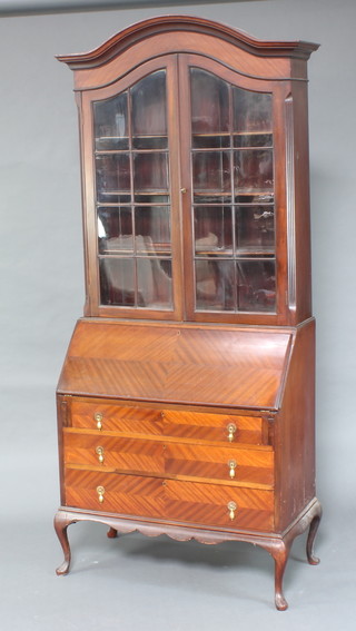 A 1930's Georgian style bureau bookcase, the upper section with domed top fitted shelves enclosed by astragal glazed doors, the base fitted a fall front above 3 long drawers raised on cabriole supports 221cm h x 92cm w x 47cm d 