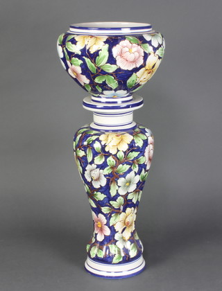 A pottery jardiniere and stand with floral decoration 