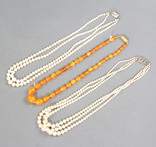 Two strings of costume pearls and a string of amber coloured beads