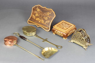 A shaped inlaid mahogany book rest, a trinket box with hinged lid, a pierced brass 2 section letter rack, a brass chestnut roaster, copper and brass ditto and a brass coal shovel 