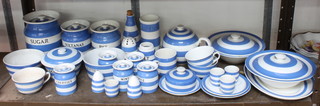A collection of T G Green and Co. blue and white striped Cornish kitchen storage jars and covers, bowls, etc,  (Some with damage and crackle to the glaze)