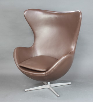 After Arne Jacobsen, an egg chair upholstered in brown leather 106cm h x 78cm w 
