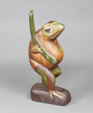 A carved wooden figure of a standing frog 54cm h 