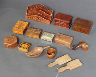 Two pairs of wooden butter pats, a pierced Indian letter rack together with a collection of wooden boxes

