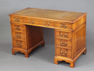 A Georgian style yew kneehole desk with inset tooled leather writing surface fitted 6 short drawers, raised on bracket feet 76cm h x 122cm w x 62cm d 