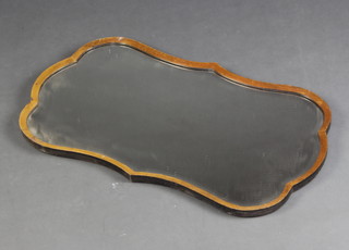 A shaped bevelled plate wall mirror contained in a walnut frame 41cm x 71cm 
