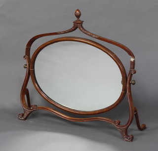 A Georgian style oval plate dressing table mirror contained in a mahogany swing frame with acorn finial to the top 67cm x 71cm x 21cm (damage to the frame) 