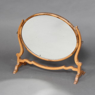 A Sheraton style oval plate dressing table mirror contained in a mahogany swing frame 51cm h x 54cm w x 23cm d (some signs of deterioration to the silvering on the mirror) 