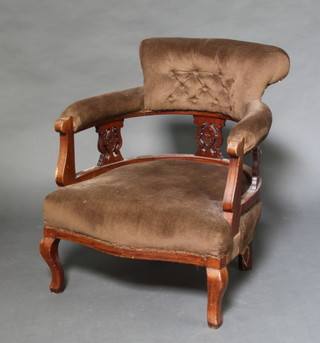 A Victorian walnut tub back chair with pierced vase shaped slat back panels, upholstered seat and back raised on cabriole supports 