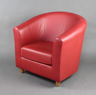 A Marks and Spencers tub back armchair upholstered in red material 