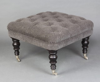 A Victorian style square stool upholstered in black buttoned material on turned supports, caps and casters 43cm h x 68cm w x 68cm d  