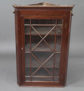 A 19th Century mahogany hanging corner cabinet with moulded and dentil cornice, fitted shelves enclosed by an astragal glazed panelled door 106cm h x 70cm w x 43cm d 