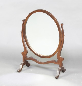 A Sheraton style oval plate dressing table mirror contained in a mahogany swing frame 61cm x 63cm x 22cm 