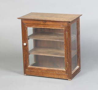 A 19th Century pine and oak topped display cabinet fitted 2 shelves enclosed by a glazed panelled door 48cm h x 45cm w x 26cm d 