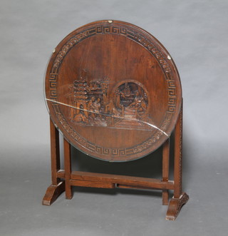 A circular carved Chinese hardwood firescreen/table with plate glass top (cracked)  54cm x 61cm diam. 