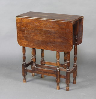 A 1930's oak drop flap gateleg tea table, raised on turned supports 72cm h x 60cm w x 31cm d 