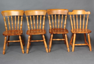 A set of 4 pine Windsor style stick and bar back dining chairs 
