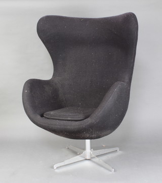 After Arne Jacobsen, a revolving egg chair upholstered in black felt material 119cm h x 78cm w 