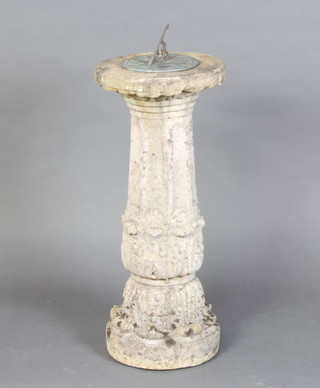 A circular sundial raised on a well weathered concrete fluted column 73cm h x 31cm diam. 