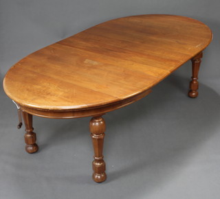 A Victorian walnut oval extending dining table with 2 extra leaves raised on chamfered supports with cup and cover decoration 77cm h x 122cm w x 167 l x 243cm l when extended 