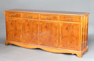A Georgian style crossbanded yew wood sideboard, fitted 4 drawers above 4 panelled doors, raised on bracket feet 80cm h x 182cm w x 46cm 