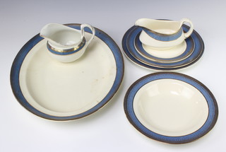 A Crescent Ivory blue and gilt dinner service comprising 8 small plates (5 chipped) 8 medium plates, 8 dinner plates (2 chipped and 1 cracked) meat plate, sauce boat A/F, jug, 8 soup bowls (1 chipped) and 4 egg cups all chipped.