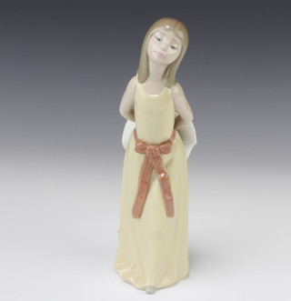 A Lladro figure of a young lady holding a bonnet behind her no. 5006 24cm 