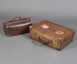 A brown leather suitcase with Cunard and Cathay Pacific labels with brass locks 12cm x 60cm x 39cm together with  a brown leather Gladstone bag 23cm x 23cm x 45cm 
