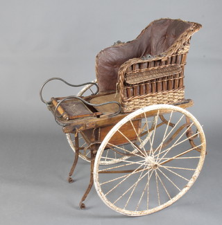A Victorian wooden and wicker work goat/dog cart with 64cm diam. solid tyres 100cm h x 63cm  x 76cm  