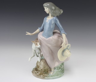 A Lladro group of a lady with hound on a rocky base 5855 26cm 